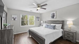 a bedroom with a bed and a ceiling fan at Porch Paradise by AvantStay New Pool Firepit in Mooresville +35 photos