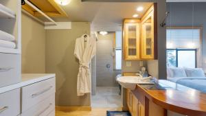 a bathroom with a sink and a shower at Deck Views Fire Pit Pool 3 Mins to Beach Madrona Tree Retreat by AvantStay in Coupeville +38 photos