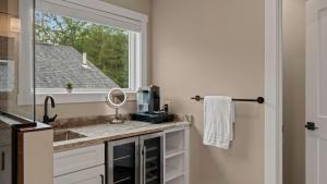 a bathroom with a sink and a window at Lakeside Serenity by AvantStay Lakefront Newly Built Deck w Views in White Haven +48 photos