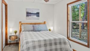a bedroom with a bed and a window at Maple Oasis by AvantStay Newly Built w Hot Tub Game Room Fire Pit in Blakeslee +40 photos