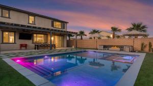 a swimming pool in front of a house at Desert Eden by AvantStay 6BR w Ensuite Backyard Oasis w Pool Hot Tub in Coachella