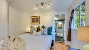 ein Schlafzimmer mit einem großen weißen Bett und Kissen in der Unterkunft Grapevine Cottage by AvantStay Hobby Vineyard Firepit in Glen Ellen