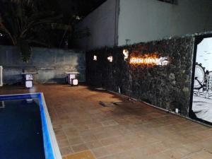 a room with a swimming pool and a stone wall at Mount Villa in Dehiwala