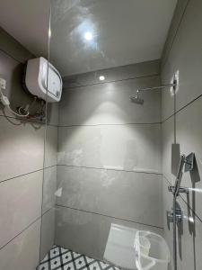 a bathroom with a shower and a toilet in it at Hotel Fortune Mandsaur in Mandsaur +45 photos