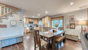 a kitchen and dining room with a table and chairs at Washoe Way by AvantStay Luxury Tahoe Retreat A Location w Beach Access in Tahoe City