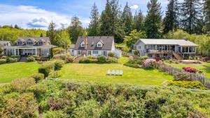an aerial view of a house with a yard at Colonial Bluff House Above the Sea by AvantStay in Langley