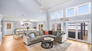a living room with a couch and a table at Ponderosa Pointe by AvantStay Boathouse Views in Mooresville