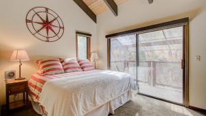 a bedroom with a bed and a large window at Quittin Time Townhouse Peaceful Mountain Ski-In-Ski-Out Retreat Close to Town in Park City