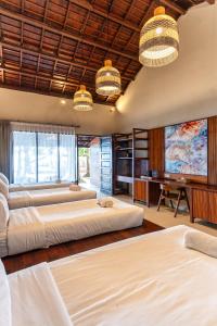 a bedroom with three beds and a flat screen tv at Sepa Island Resort in Pulau Tondan Barat +34 photos