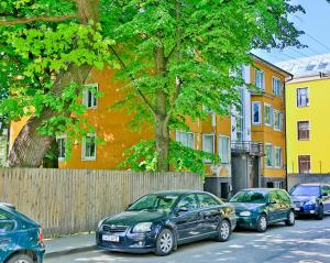 a group of cars parked on the side of a street at Heart of Kalamaja Apartment in Tallinn