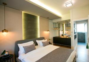 a hotel room with a large bed and a large mirror at 47 Luxury Suites in Athens