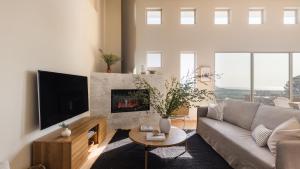 a living room with a couch and a fireplace at Seascape by AvantStay Spacious Contemporary Oasis in Del Mar in San Diego
