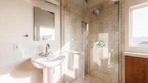 a bathroom with a sink and a glass shower at Seascape by AvantStay Spacious Contemporary Oasis in Del Mar in San Diego +26 photos