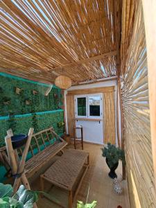 a room with a bench and a table and a window at Essaouira Stay with private Terrace in Essaouira