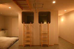 a room with two ladders next to a bed at BROOMSTAY Umeda west in Osaka +38 photos