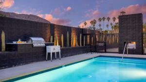 a swimming pool in front of a house at Blackhaus B : 4 Bedroom Suite by AvantStay 4-Rooms in Palm Springs
