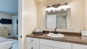a bathroom with a sink and a mirror at Polnell Point Lookout by AvantStay Water Views Hot Tub Large Patio in Oak Harbor +33 photos