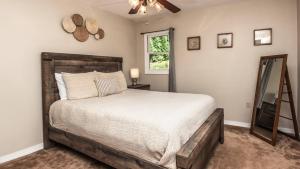 a bedroom with a large bed and a window at Hickory Nut Hideaway by AvantStay Mountain Views in Gerton