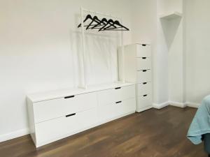 a white dresser in a room with white walls at EinKlang - Familienidyll in Seesen
