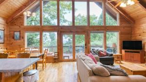 a living room and dining room with a large window at Mountain Gem by AvantStay Incredible Views in Waynesville