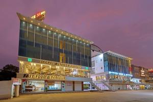 a store front of a shopping center at night at Hotel Sai Inn at Statue of Unity in Rājpīpla