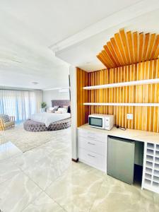 a living room with a bedroom and a bed at Alimu villa in Nelspruit