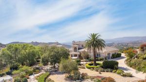 a house with a palm tree in a garden at Camila by AvantStay 18-Person Temecula Mansion in Temecula