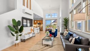 a living room with a couch and a table at Ocean Views Modern New Build Yard 10min to Beach Ocean Escape by AvantStay in Waianae