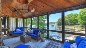 Un porche cubierto con sillas azules y vista al agua. en Oasis at Ballycastle by AvantStay Private Beach, en Westport