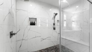 a bathroom with a shower with a glass door at Laid Back Lake Life by AvantStay Waterfront View in Mooresville +42 photos