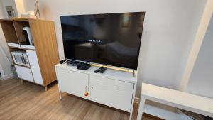 a living room with a large flat screen tv at Marine City Cozy Stay in Busan