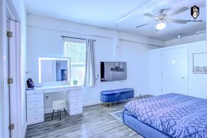 a bedroom with a bed and a desk and a mirror at The Stallion #305 - Walk to Attractions - Modern Spacious 1BD Loft in Memphis Downtown in Memphis