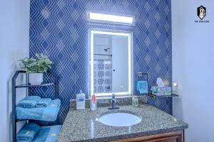 a bathroom with a sink and a mirror at The Stallion #305 - Walk to Attractions - Modern Spacious 1BD Loft in Memphis Downtown in Memphis +19 photos