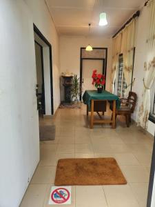 a living room with a table and a chair at Hansa Villa in Bentota