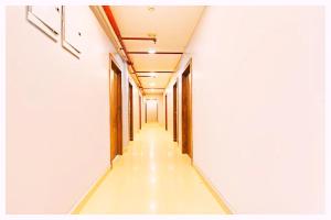 an empty corridor in a building with a long hallway at Hotel BNK Residency Near Temple and Railway Station in Ujjain