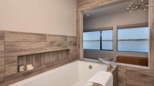 a bathroom with a tub and a large window at Langley Waterfront Condo by AvantStay A Views in Langley +74 photos