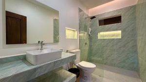 a bathroom with a sink and a toilet and a shower at Sala Khmer - Traditional Wooden House & Garden in Siem Reap +20 photos