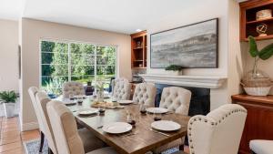 a dining room with a table and chairs and a fireplace at Grapevine by AvantStay Secluded 5BR Villa 4 Acres of Vineyards Avo Groves in Temecula