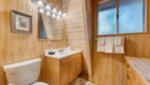 a bathroom with a white toilet and a sink at Lundy Bearden Serene Tahoe Retreat with Deck Fireplace and Forest Views in Carnelian Bay +80 photos
