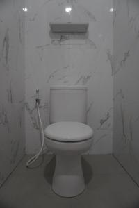 a bathroom with a white toilet and a sink at Villa Caldera C6 Batu in Tlekung +9 photos