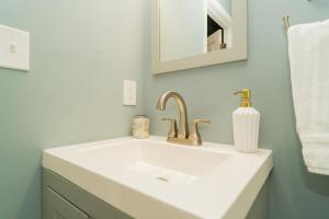 a bathroom with a white sink and a mirror at Downtown upper canton 3 bdrm 3 bath home with rooftop and parking pad in Baltimore +126 photos