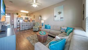 a living room with a couch and a dining room at The Beautiful Place by AvantStay Mins to Beach Family-Friendly Pool in Padre Island