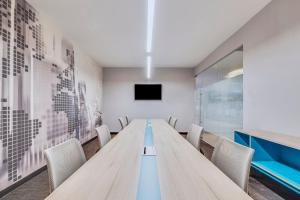 a conference room with a long table and chairs at One Ciudad de Mexico Patriotismo in Mexico City