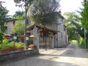 an entrance to a building with a fence and flowers at Villa Tacco in Quarata