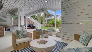 a living room with a table and chairs at Be a Sullivans Local 1307 Cove Avenue by AvantStay Pool Outdoor Living in Sullivans Island