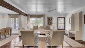 a living room with a couch and chairs and a table at Be a Sullivans Local 1307 Cove Avenue by AvantStay Pool Outdoor Living in Sullivans Island