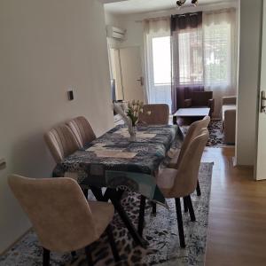 a dining room with a table and chairs at Zenith Apartment in Bitola