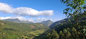 a view of a valley with mountains in the background at Dadysmud house in Kottakamboor