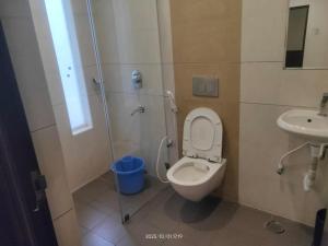 a bathroom with a toilet and a sink at Hotel Orion Inn in Tirupati