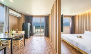 a hotel room with a bed and a dining table at Ocean 2 You Resort Seorak Beach Hotel & Condo in Sokcho +111 photos